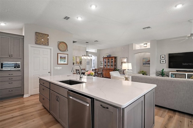 8545 SE 168th Kittredge Loop, The Villages, FL 32162 - kitchen with appliances with stainless steel finishes, gray cabinetry, arched walkways, open floor plan, and light wood-type flooring