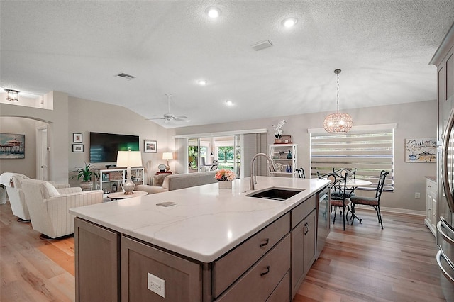 8545 SE 168th Kittredge Loop, The Villages, FL 32162 - kitchen with light wood-type flooring, ceiling fan, lofted ceiling, a center island with sink, and open floor plan