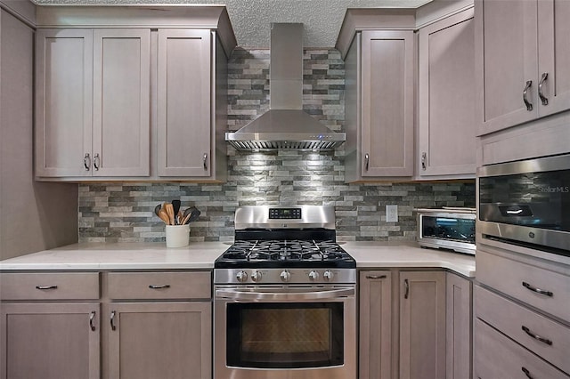 8545 SE 168th Kittredge Loop, The Villages, FL 32162 - kitchen featuring appliances with stainless steel finishes, wall chimney range hood, decorative backsplash, light countertops, and a textured ceiling