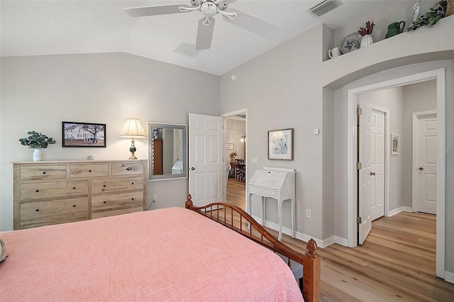 8545 SE 168th Kittredge Loop, The Villages, FL 32162 - bedroom with light wood-style floors, vaulted ceiling, and ceiling fan