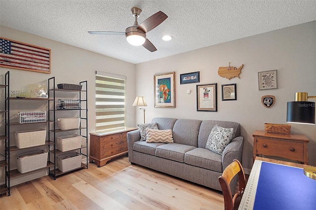 8545 SE 168th Kittredge Loop, The Villages, FL 32162 - living area with light wood-style flooring, a textured ceiling, and a ceiling fan