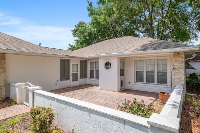 11146 SW 68th Ct, Ocala, FL 34476 - view of front of property with fence, a patio area, and roof with shingles