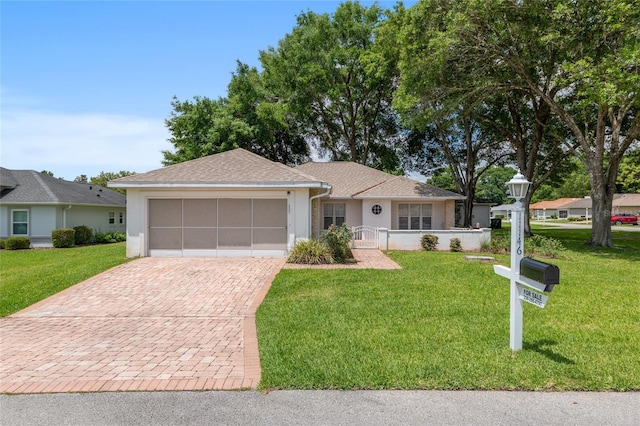 11146 SW 68th Ct, Ocala, FL 34476 - single story home featuring roof with shingles, decorative driveway, a front lawn, an attached garage, and stucco siding