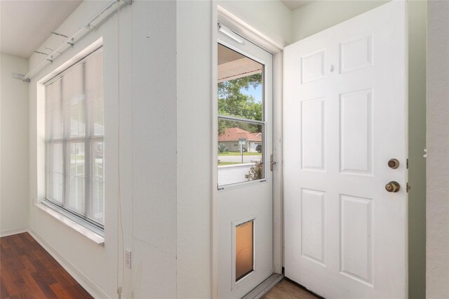 11146 SW 68th Ct, Ocala, FL 34476 - doorway with dark wood-style flooring and baseboards