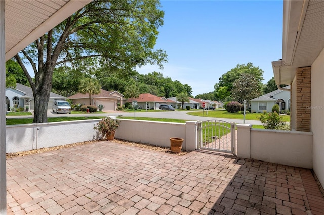 11146 SW 68th Ct, Ocala, FL 34476 - view of patio featuring decorative driveway, a residential view, and a gate