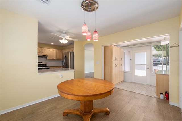11146 SW 68th Ct, Ocala, FL 34476 - kitchen featuring light countertops, stainless steel appliances, backsplash, under cabinet range hood, and visible vents