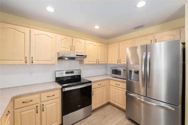 11146 SW 68th Ct, Ocala, FL 34476 - kitchen featuring decorative backsplash, light brown cabinetry, light wood-type flooring, under cabinet range hood, and stainless steel appliances