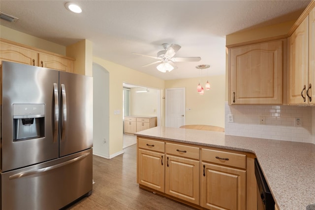 11146 SW 68th Ct, Ocala, FL 34476 - kitchen with light brown cabinetry, stainless steel fridge with ice dispenser, a ceiling fan, and a peninsula