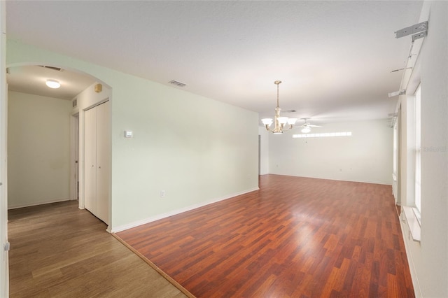 11146 SW 68th Ct, Ocala, FL 34476 - empty room with arched walkways, a chandelier, baseboards, wood finished floors, and visible vents