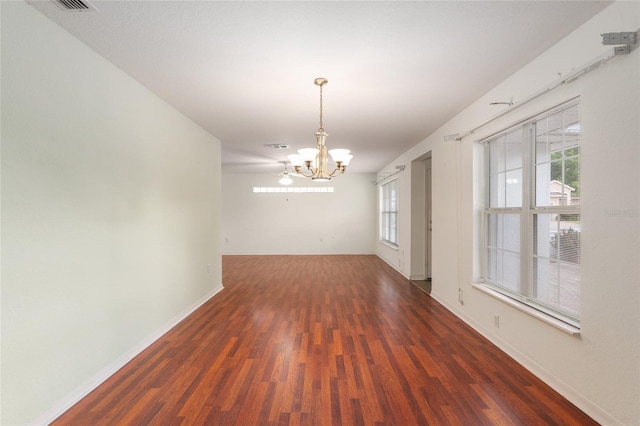 11146 SW 68th Ct, Ocala, FL 34476 - unfurnished dining area with baseboards, an inviting chandelier, a healthy amount of sunlight, and wood finished floors