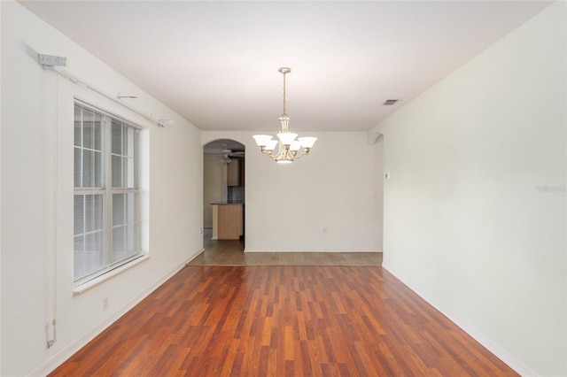 11146 SW 68th Ct, Ocala, FL 34476 - empty room with arched walkways, visible vents, wood finished floors, and ceiling fan with notable chandelier
