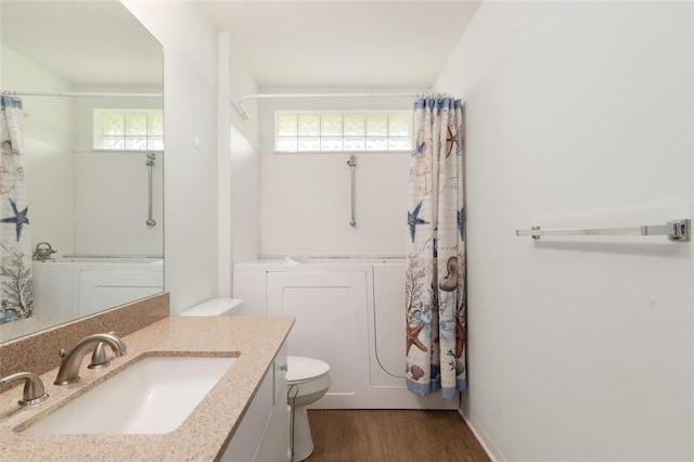 11146 SW 68th Ct, Ocala, FL 34476 - bathroom with vanity, toilet, wood finished floors, and washer and clothes dryer