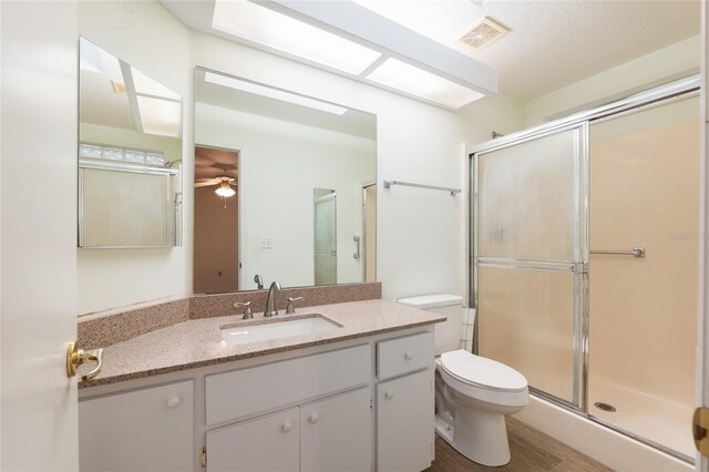 11146 SW 68th Ct, Ocala, FL 34476 - bathroom with vanity, toilet, a ceiling fan, visible vents, and a stall shower