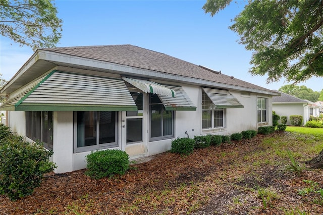 11146 SW 68th Ct, Ocala, FL 34476 - rear view of property with a shingled roof and stucco siding