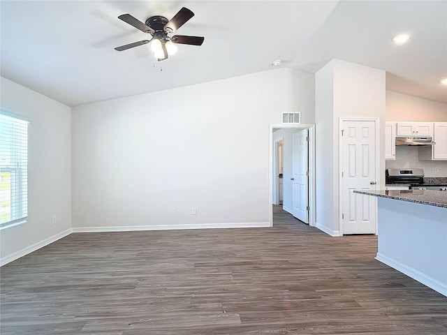 unfurnished living room with ceiling fan, vaulted ceiling, dark wood-style flooring, and visible vents