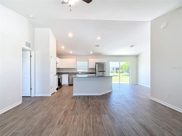 kitchen featuring a ceiling fan, dark wood-style flooring, visible vents, baseboards, and stainless steel appliances
