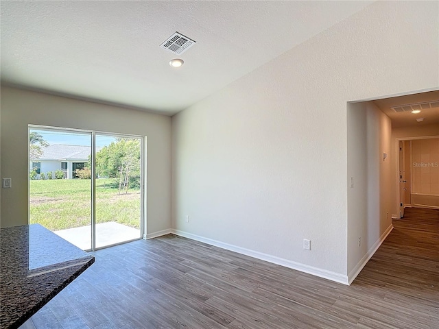 interior space featuring visible vents, baseboards, and wood finished floors