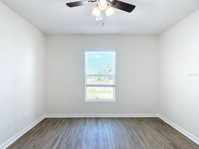 unfurnished room with baseboards, ceiling fan, and wood finished floors