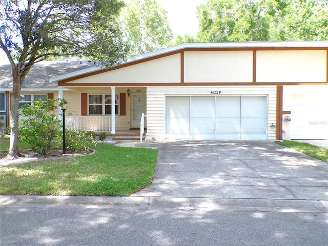 ranch-style house featuring a porch, a garage, a front lawn, and concrete driveway