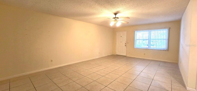 unfurnished room with light tile patterned floors, baseboards, ceiling fan, and a textured ceiling