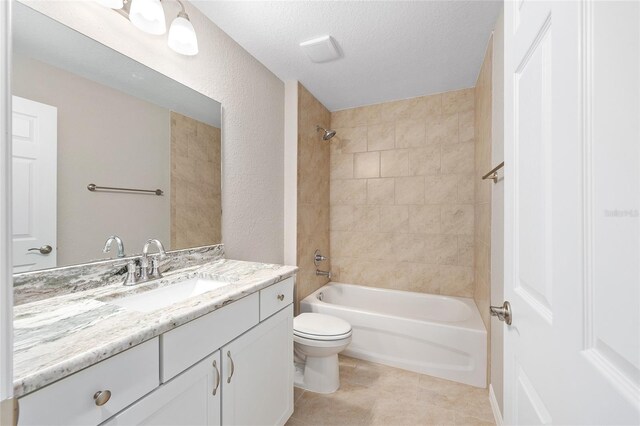 bathroom with a textured ceiling, bathtub / shower combination, vanity, tile patterned floors, and toilet
