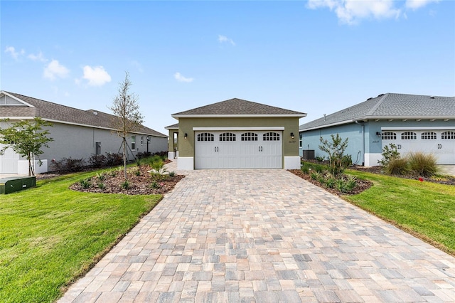 10347 SW 99th Ln, Ocala, FL 34481 - view of front facade with stucco siding, a front yard, decorative driveway, and central AC