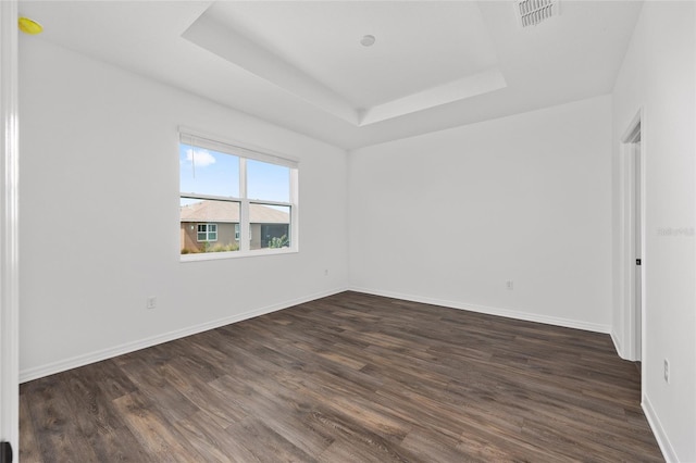 10347 SW 99th Ln, Ocala, FL 34481 - spare room with a raised ceiling, dark wood-style floors, and baseboards