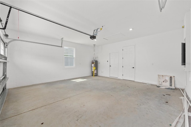 10347 SW 99th Ln, Ocala, FL 34481 - garage featuring water heater, a garage door opener, and recessed lighting