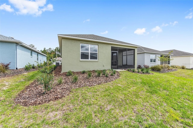 10347 SW 99th Ln, Ocala, FL 34481 - rear view of property featuring a sunroom, a lawn, and stucco siding
