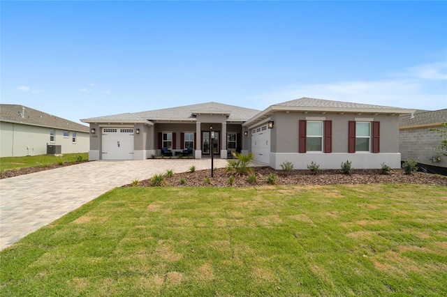 10082 SW 82nd Place Rd, Ocala, FL 34481 - prairie-style home featuring a garage, stucco siding, a front lawn, and cooling unit