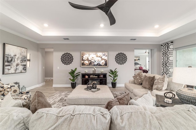 10082 SW 82nd Place Rd, Ocala, FL 34481 - living room featuring a ceiling fan, a raised ceiling, light wood-type flooring, baseboards, and ornamental molding