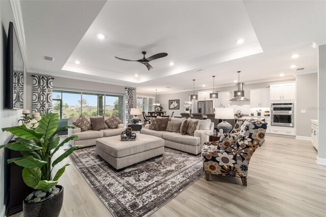 10082 SW 82nd Place Rd, Ocala, FL 34481 - living area featuring a raised ceiling, ceiling fan, light wood finished floors, recessed lighting, and ornamental molding