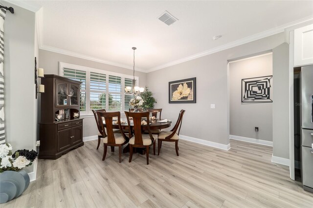 10082 SW 82nd Place Rd, Ocala, FL 34481 - dining room with light wood-style floors, baseboards, crown molding, and a chandelier
