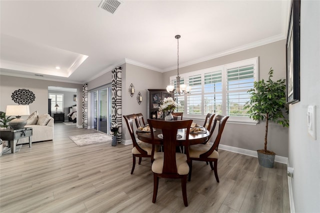 10082 SW 82nd Place Rd, Ocala, FL 34481 - dining room featuring light wood finished floors, baseboards, healthy amount of natural light, a chandelier, and crown molding