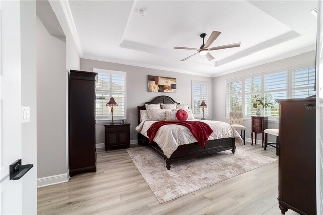 10082 SW 82nd Place Rd, Ocala, FL 34481 - bedroom with a raised ceiling, crown molding, light wood finished floors, baseboards, and ceiling fan