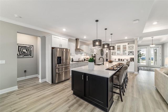 10082 SW 82nd Place Rd, Ocala, FL 34481 - kitchen featuring appliances with stainless steel finishes, a sink, wall chimney exhaust hood, light wood-type flooring, and ornamental molding