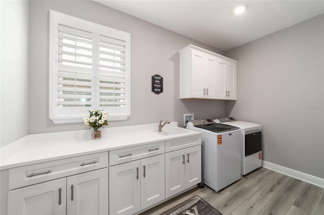 10082 SW 82nd Place Rd, Ocala, FL 34481 - laundry room with cabinet space, washer and clothes dryer, and light wood-style flooring