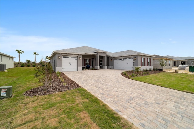 10082 SW 82nd Place Rd, Ocala, FL 34481 - prairie-style home with a garage, a front yard, central AC, and decorative driveway