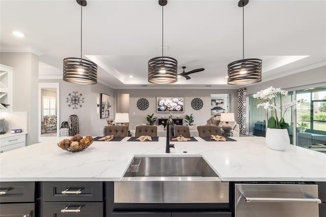 10082 SW 82nd Place Rd, Ocala, FL 34481 - kitchen featuring a tray ceiling, ornamental molding, a sink, open floor plan, and dishwasher