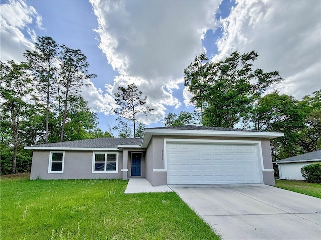 single story home featuring an attached garage, stucco siding, a front yard, and concrete driveway