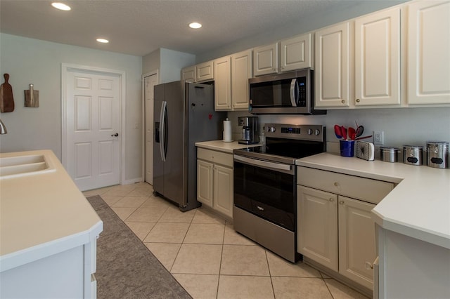 15691 SW 11th Court Rd, Ocala, FL 34473 - kitchen featuring a sink, light tile patterned floors, light countertops, stainless steel appliances, and recessed lighting