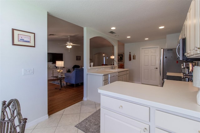 15691 SW 11th Court Rd, Ocala, FL 34473 - kitchen featuring visible vents, arched walkways, dishwasher, light tile patterned floors, and stainless steel microwave