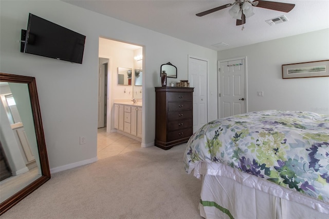 15691 SW 11th Court Rd, Ocala, FL 34473 - bedroom with visible vents, baseboards, ensuite bathroom, light colored carpet, and a sink