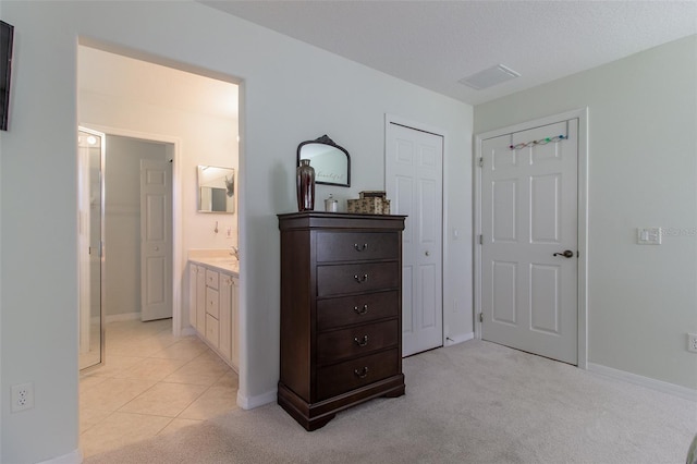 15691 SW 11th Court Rd, Ocala, FL 34473 - bedroom featuring baseboards, visible vents, light carpet, and ensuite bathroom