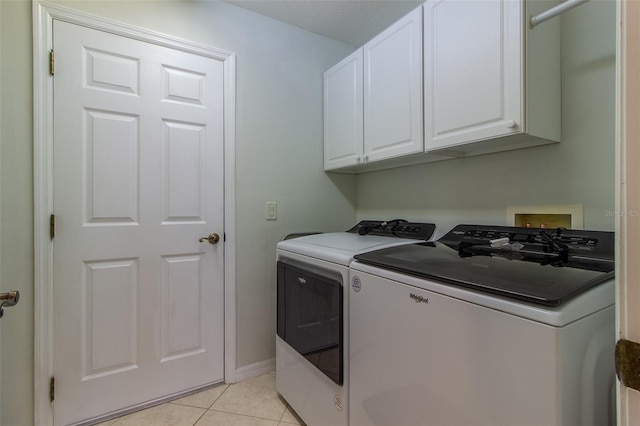 15691 SW 11th Court Rd, Ocala, FL 34473 - washroom with separate washer and dryer, cabinet space, baseboards, and light tile patterned flooring