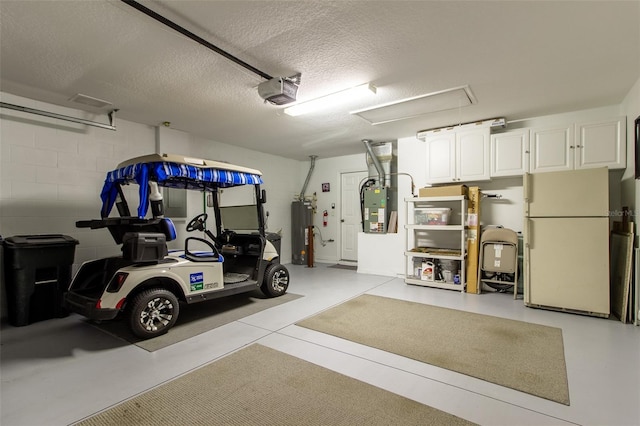 15691 SW 11th Court Rd, Ocala, FL 34473 - garage featuring freestanding refrigerator, a garage door opener, water heater, and heating unit