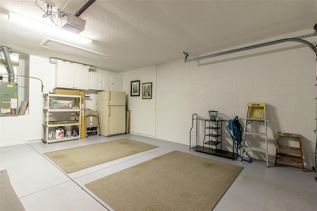 15691 SW 11th Court Rd, Ocala, FL 34473 - garage with concrete block wall, a garage door opener, and freestanding refrigerator