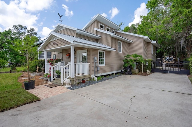 536 NW 7th Ave, Crystal River, FL 34428 - bungalow-style house with a gate, covered porch, and concrete driveway