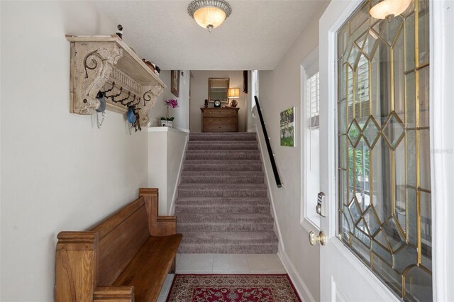 536 NW 7th Ave, Crystal River, FL 34428 - entryway featuring baseboards, tile patterned floors, and stairway