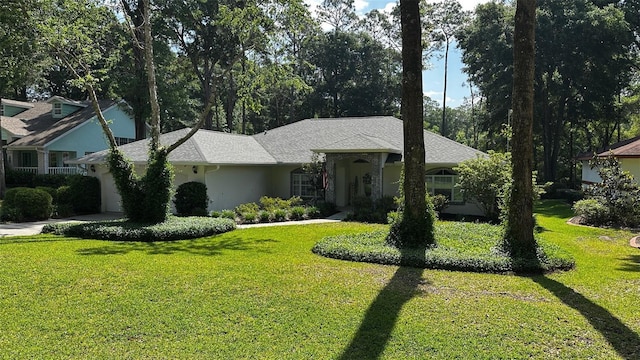 ranch-style home with an attached garage, stucco siding, and a front lawn